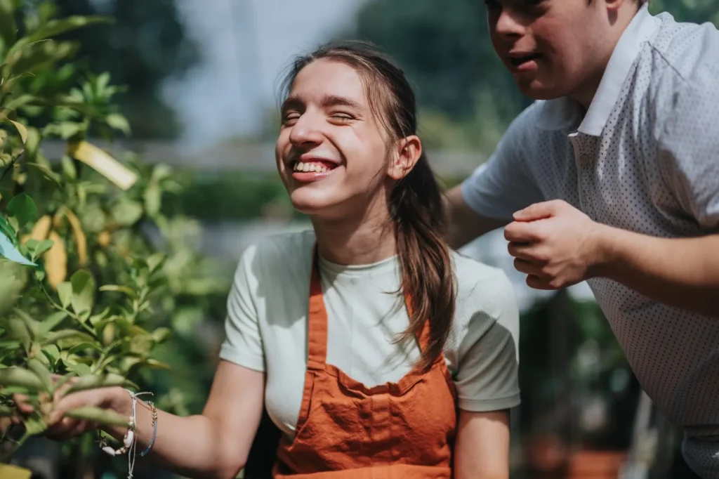 Two happy disabled friends outside